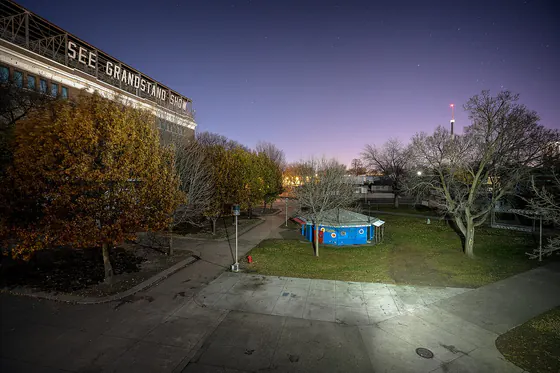 The Grandstand at dusk, its lights coming on over the fairgrounds
