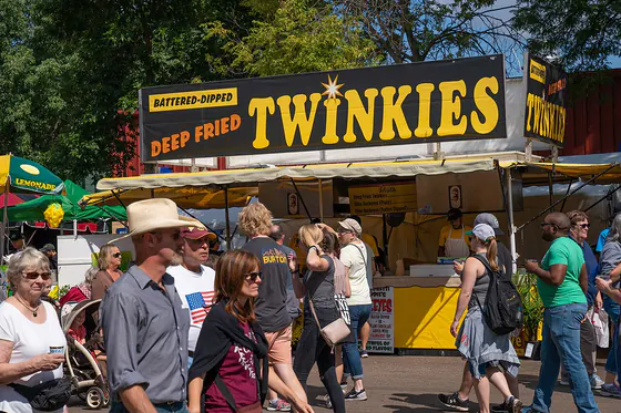 Fairgoers queuing at a Batter Dipped Deep Fried Twinkies stand