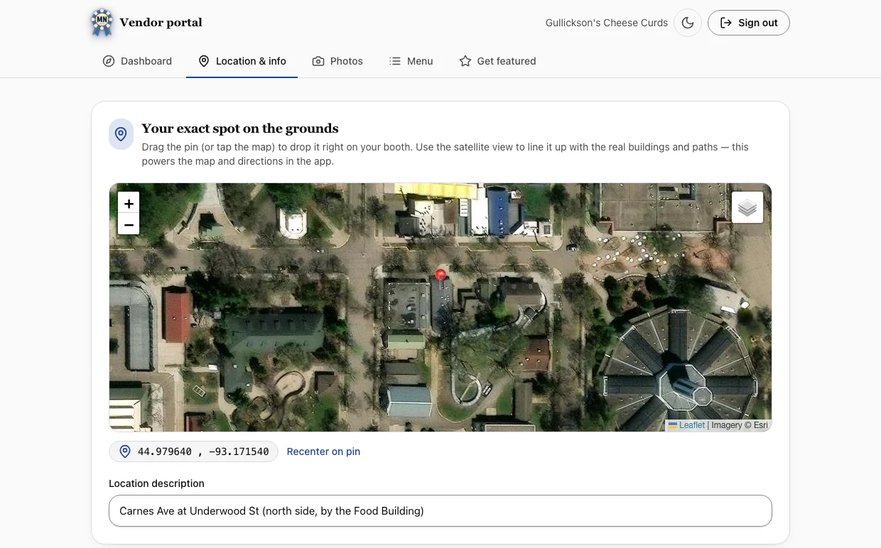 The MN Fair Guide vendor portal on the Location and info tab: a satellite map of the fairgrounds with the booth's pin dropped on Carnes Ave, its coordinates, and its location description filled in